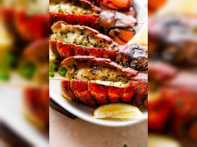 A delicious platter of grilled lobster tails garnished with herbs and lemon, perfect for onboard dining experiences or seafood lovers.