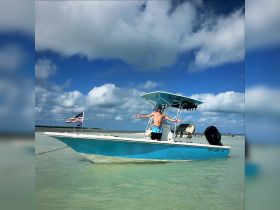 A man enjoys a sunny day on a boat, showcasing the perfect blend of adventure and relaxation on the water.