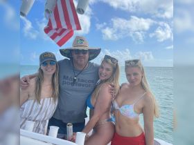 A fun group of friends enjoys a day on the water, celebrating with drinks and laughter aboard a boat — perfect for summer outings and memorable adventures.