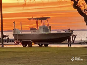 A speedboat is docked at sunset, with a person preparing for departure — a picturesque scene perfect for evening outings on the water.