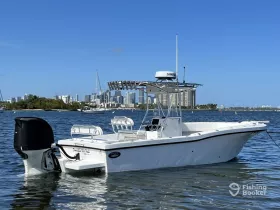 A sleek speedboat anchored in calm waters with a vibrant city skyline in the background, perfect for day trips and water adventures.