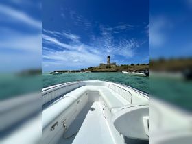 A clean and spacious interior view of a boat, showcasing comfortable seating and a helm, perfect for enjoying a day on the water.