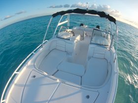 A spacious and well-appointed interior view of a boat's helm and seating area, perfect for comfortable cruising on the open water.