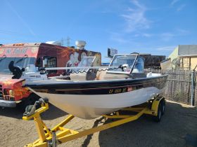 A sleek boat is showcased on a trailer, highlighting its design and features, perfect for fishing or leisure outings.