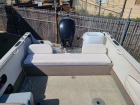 Interior view of a boat showcasing the seating area and helm, ideal for comfortable cruising and relaxation on the water.