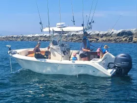 A family enjoys a fishing trip aboard a Cobia boat, creating lasting memories with children actively participating in the fun on the water.