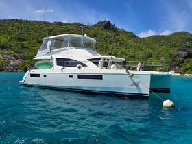 A stunning view of a Leopard 51 catamaran anchored in crystal-clear waters, surrounded by lush greenery — perfect for exploring tropical destinations.