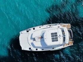 Aerial view of a yacht with guests enjoying the water, showcasing the vibrant turquoise sea — perfect for summer adventures and relaxation.