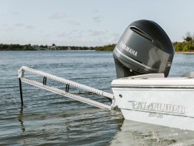 A sleek Pathfinder 2600 boat featuring a Yamaha outboard motor, captured in tranquil waters, showcasing its design and functionality.