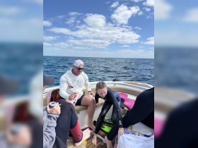 A family enjoys a fun day on the water, preparing for snorkeling aboard their boat — perfect for creating lasting memories together.