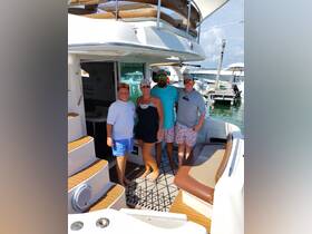 A cheerful family poses together on their boat, showcasing a perfect day on the water — ideal for family outings and memorable adventures.