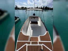 A clean and spacious interior view of a boat's helm and seating area, perfect for enjoying a day on the water.