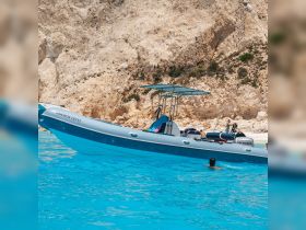A vibrant scene featuring a boat anchored near a stunning beach, with people enjoying the clear blue waters — perfect for summer adventures and beach outings.
