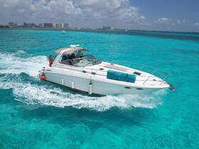 A sleek boat navigates through stunning turquoise waters, showcasing a perfect day on the water with friends or family.