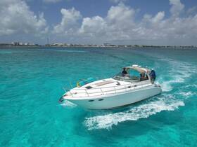 A sleek boat navigates through stunning turquoise waters, showcasing a perfect day on the water with friends or family.