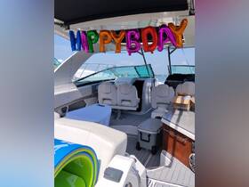The interior of a boat is decorated with colorful 'Happy Birthday' balloons, creating a festive atmosphere for celebrations on the water.