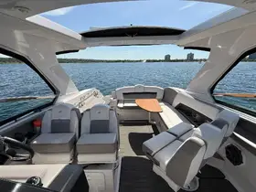 A spacious and modern interior view of a boat's helm and seating area, showcasing comfortable seating and a sleek design, perfect for relaxing on the water.