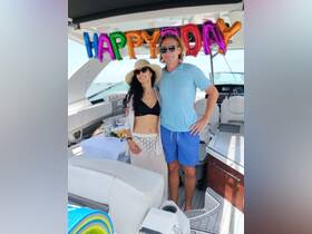 A couple celebrates a birthday on a yacht, surrounded by festive decorations and a beautiful ocean backdrop — perfect for memorable moments on the water.