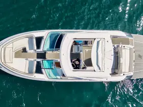 Aerial view of a sleek yacht showcasing its spacious deck and luxurious seating, perfect for enjoying time on the water.