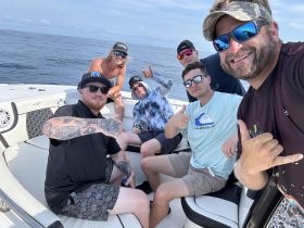 A group of friends enjoying a day on the water, showcasing camaraderie and fun aboard their boat. Perfect for capturing memorable moments during a boating adventure.