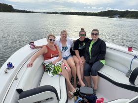 A group of friends enjoys a relaxing day on the water, capturing the essence of fun and camaraderie aboard their boat.