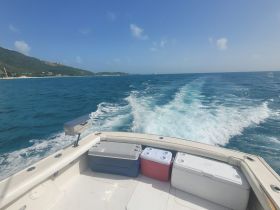 A view from the boat showcasing coolers on deck, perfect for storing refreshments during a day out on the water.