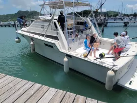 A lively group of friends enjoys time aboard a fishing boat, creating memorable moments on the water. Perfect for family outings and fishing adventures.
