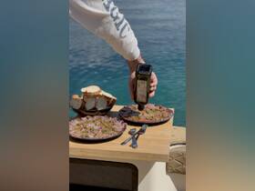 A delicious spread of charcuterie and bread is prepared on a boat, perfect for enjoying gourmet meals while cruising on the water.