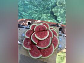 A vibrant display of freshly sliced watermelon on a boat, perfect for enjoying a refreshing snack while relaxing on the water.