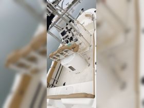 An interior view of a well-equipped boat helm featuring seating and control console, perfect for navigating the waters with comfort and style.