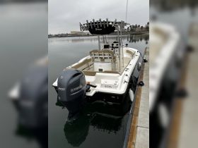 A sleek center console boat docked peacefully, showcasing its Yamaha engine and spacious design, perfect for fishing or day cruising.