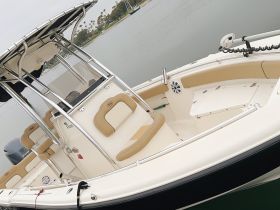 Interior view of a well-equipped boat helm featuring comfortable seating and a sleek console, perfect for a day on the water.