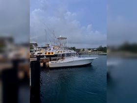A sleek yacht docked at the marina, showcasing its elegant design against a tranquil evening backdrop — perfect for luxury charters and fishing trips.