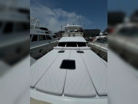 A pristine view of a yacht's deck, showcasing its luxurious design and spacious layout, perfect for relaxation at the marina.