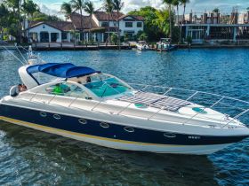 A stylish yacht with guests enjoying their time on the water, showcasing the perfect setting for a day of relaxation and fun.