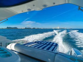 A view from the helm of a luxurious boat, showcasing comfortable seating and a clear blue sky — perfect for a day on the water.