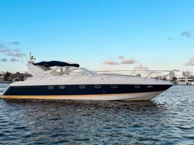 A sleek yacht glides through calm waters, showcasing its elegant design against a clear blue sky — perfect for luxury outings and coastal adventures.