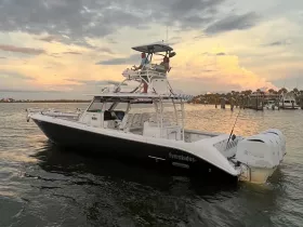 A sleek Everglades speedboat navigates the water at sunset, showcasing its stylish design and powerful performance.