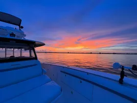 A stunning sunset view from the deck of an Everglades boat, showcasing tranquil waters and vibrant colors — perfect for evening cruises.