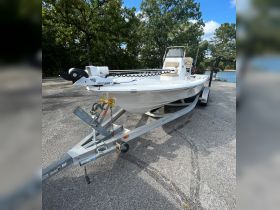 A sleek fishing boat is docked and ready for adventure, showcasing its streamlined design and features, perfect for a day on the water.