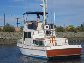 A classic yacht navigates through calm waters, showcasing its elegant design and structure. Perfect for luxury charters or leisurely cruises.