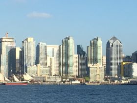 A view of a city skyline with a partial glimpse of a boat; the image lacks clarity and detail.