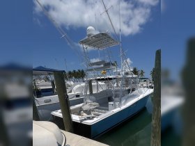 A side view of a fishing boat docked at the marina, showcasing its sleek design and fishing equipment — perfect for anglers looking for their next adventure.