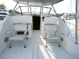 The interior of a boat helm featuring comfortable seating and a spacious layout, ideal for navigating the waters in style.