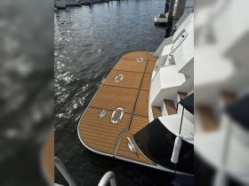 A close-up view of a boat's dock area, showcasing the elegant wooden decking and sleek design, perfect for luxury boating experiences.