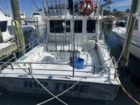 The interior of the 'Rip Tide' fishing boat showcases its helm and fishing gear, ideal for anglers looking to embark on a deep-sea adventure.