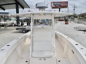 Interior view of a boat's helm and seating area, showcasing a clean and spacious design ideal for fishing or cruising.