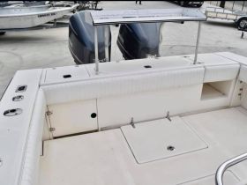 Interior view of a boat's helm and seating area, showcasing a clean and functional design ideal for fishing or leisure outings.