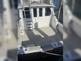 Interior view of a boat's helm area, showcasing the spacious layout and design, perfect for comfortable navigation and relaxation.