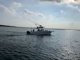 A speedboat navigates through calm waters, showcasing an exciting day on the water with friends or family.